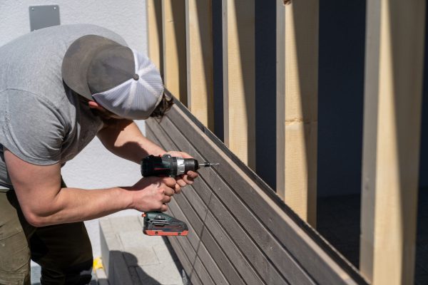 a-tough-construction-worker-applies-wooden-siding-2025-10-16-22-08-13-utc